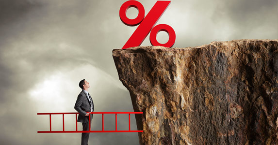 a man standing on a red bridge over a cliff