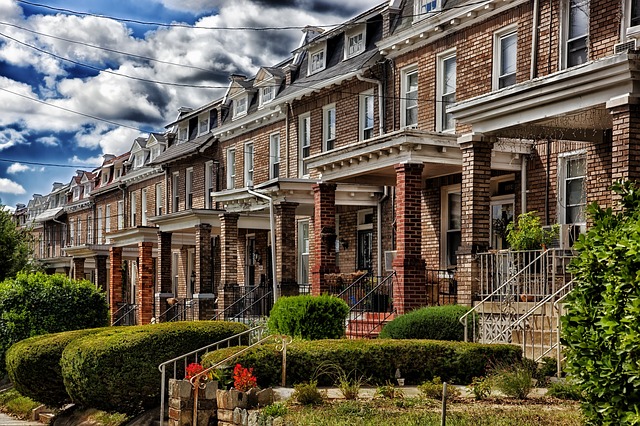a row of brick townhouses on a cloudy day