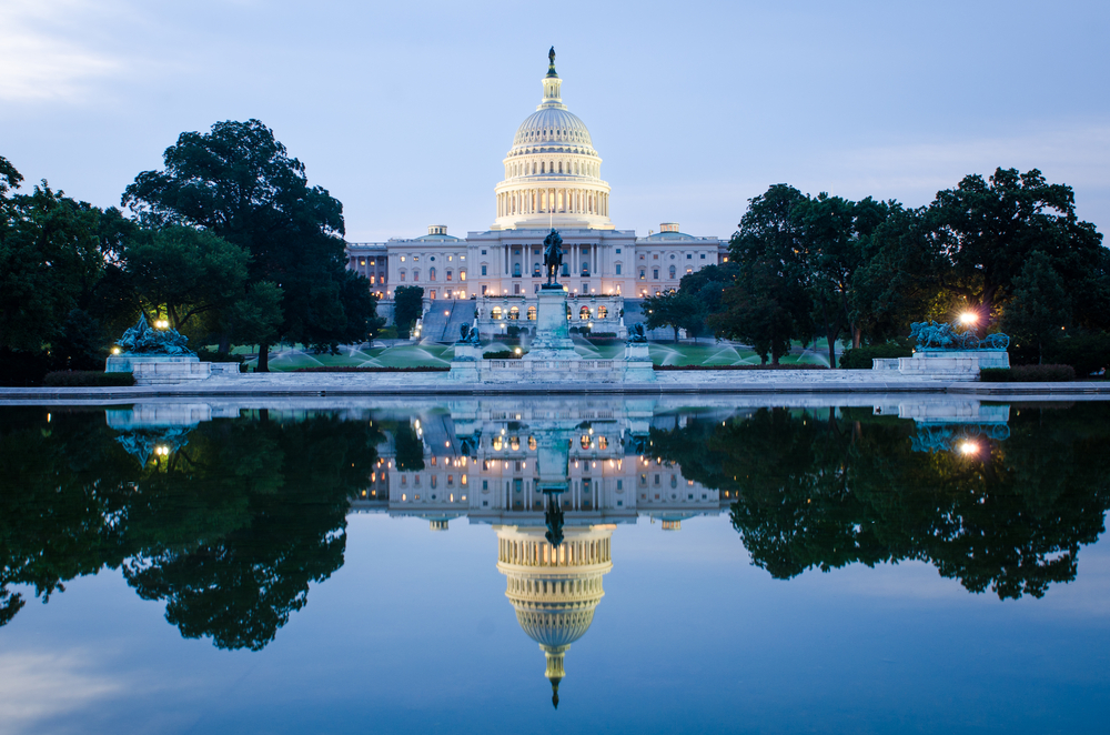 the capitol building is reflected in the water