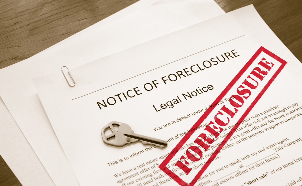 a notice of foreclosure with a key on it