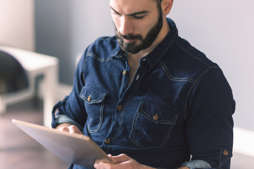 a man with a beard is looking at something