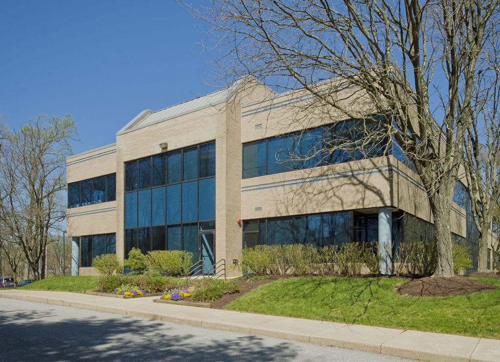 a large building with many windows and trees