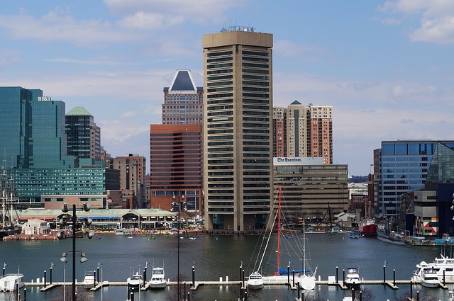 a harbor filled with lots of boats next to tall buildings