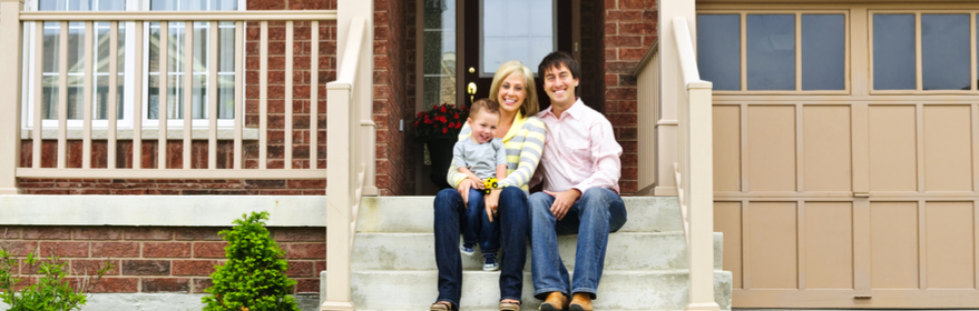 a man and woman sitting on the steps of a house