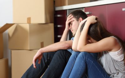 a man and woman sitting next to each other on the floor