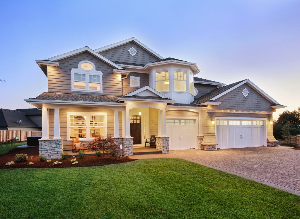 a large house with a lot of windows and lights