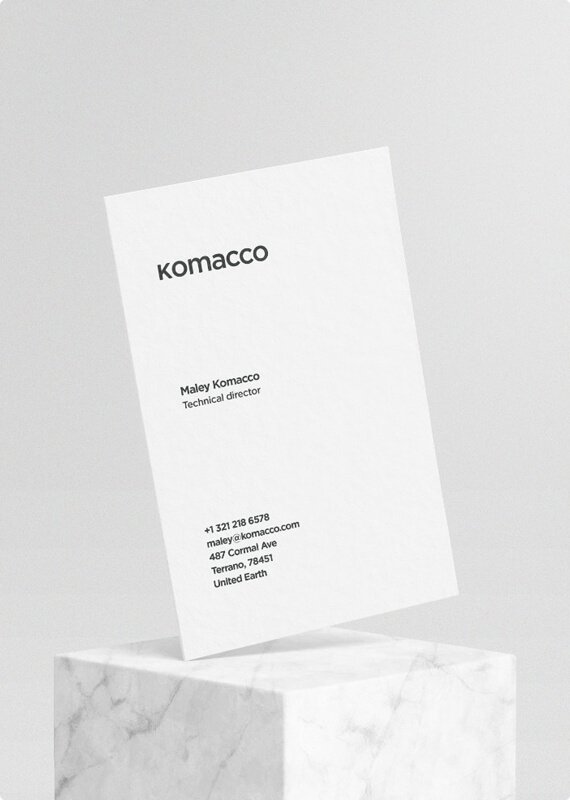 a white business card sitting on top of a marble block