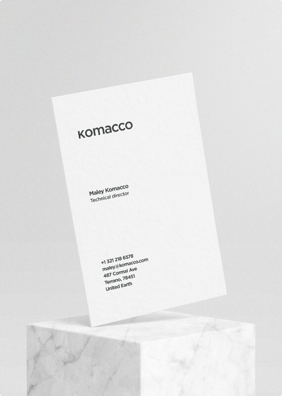 a white business card sitting on top of a marble block
