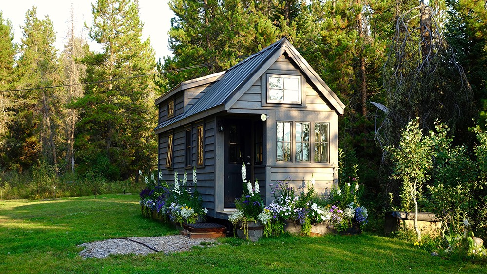 a small house in the middle of a field