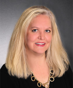 a woman with blonde hair wearing a necklace