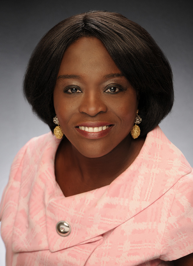 an african american woman in a pink dress