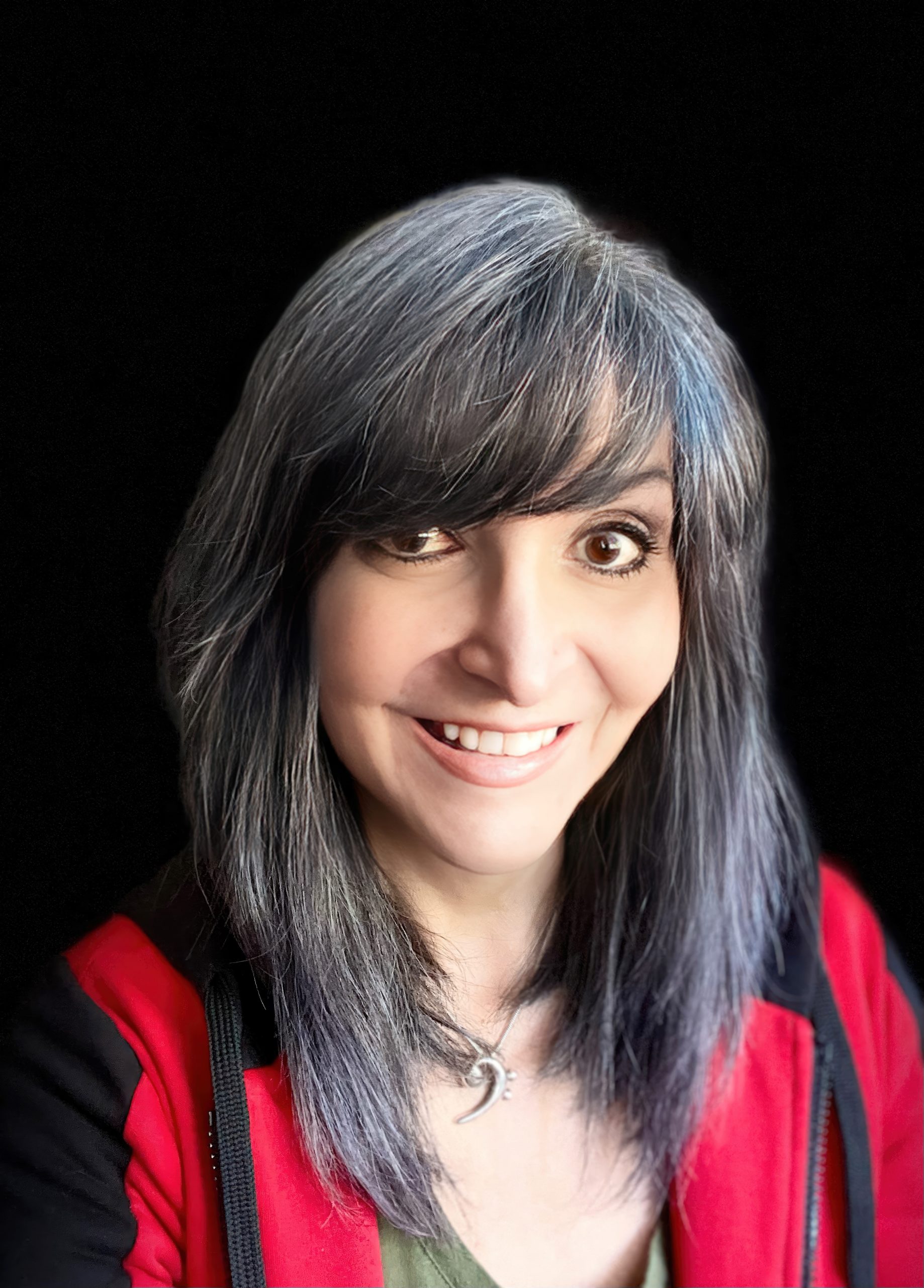 a woman with grey hair is smiling at the camera