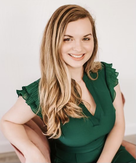 a woman in a green dress posing for a photo