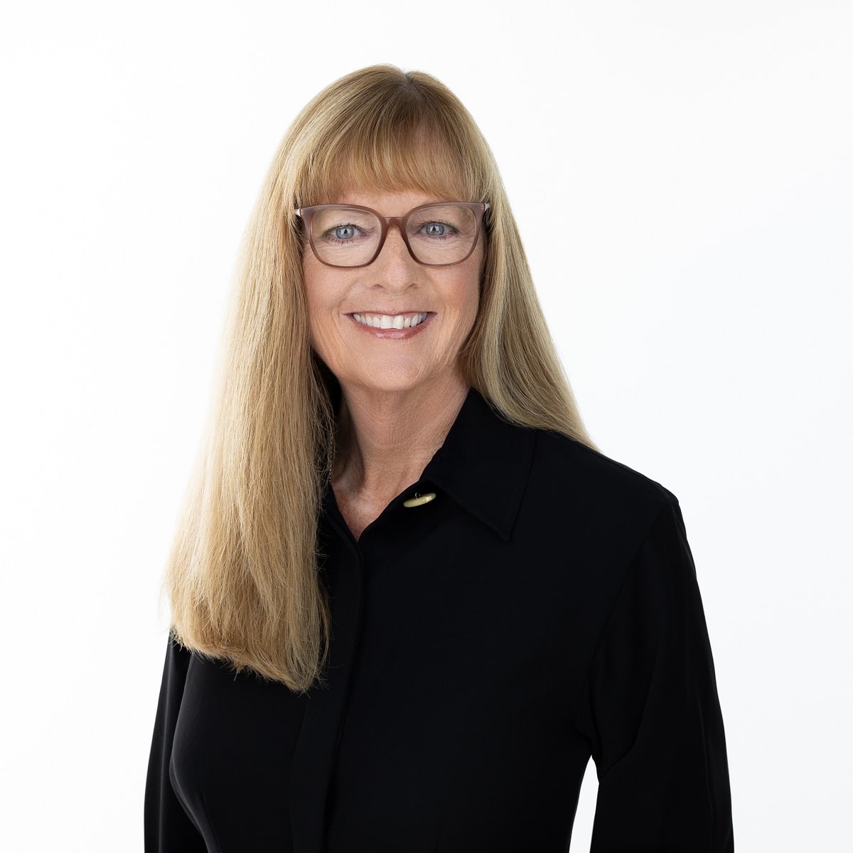 a woman wearing glasses and a black shirt