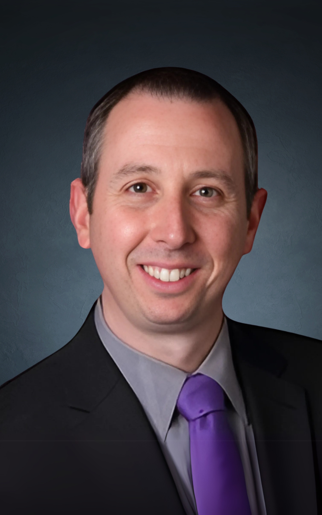 a man in a suit and purple tie